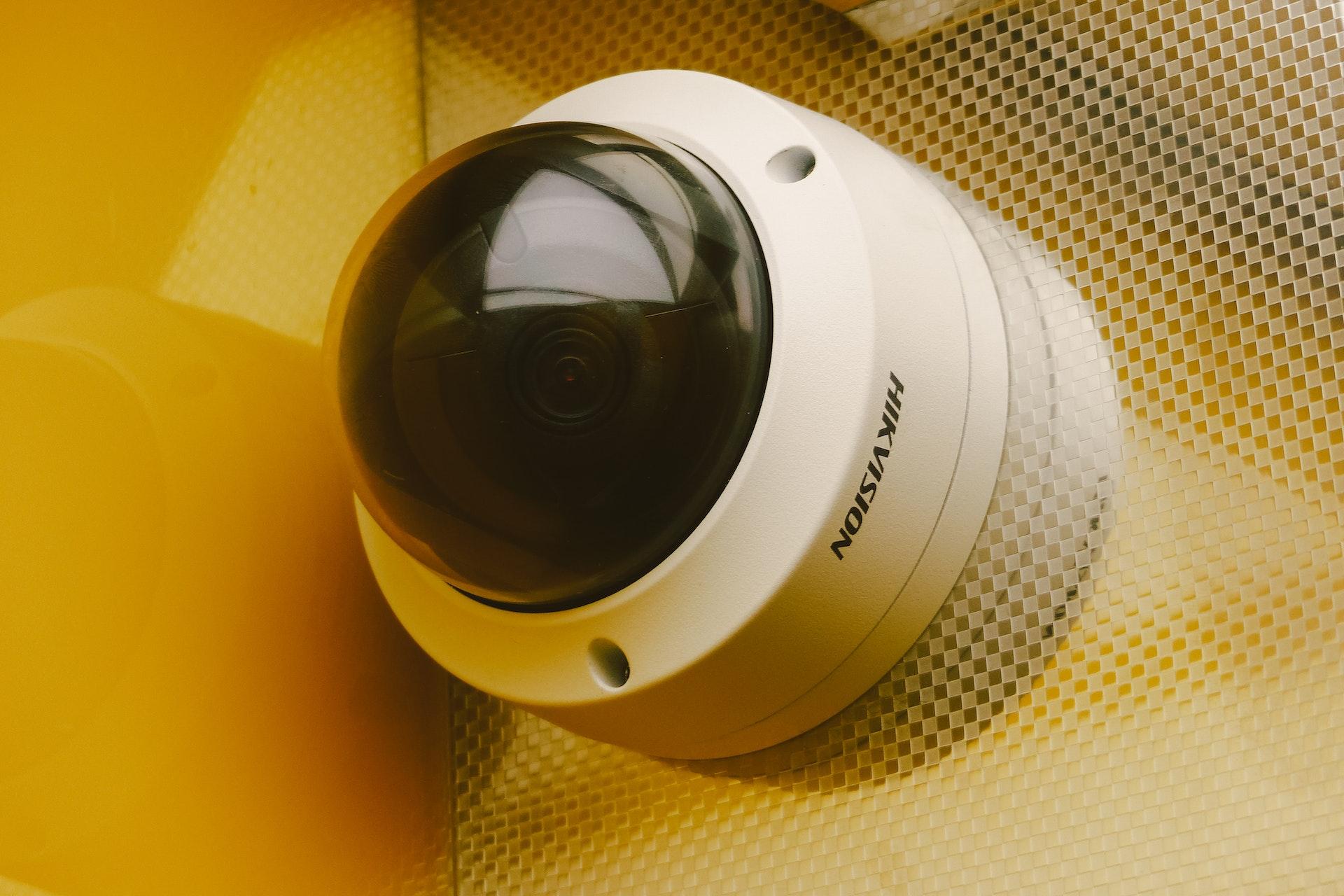 A commercial dome-style CCTV camera installed on a wall